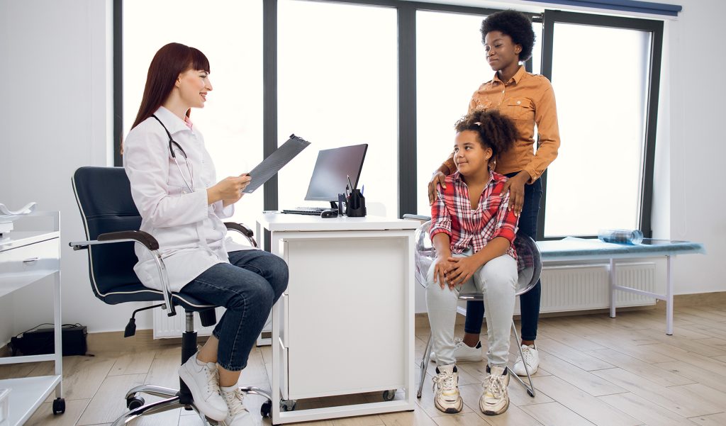 Adolescente na menarca visitando o médico.